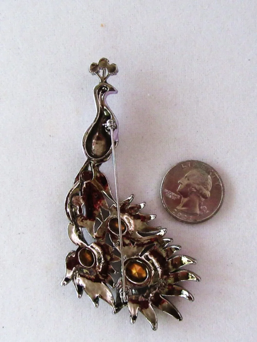 Peacock brooch with purple and aurora borealis rhinestones in silver setting